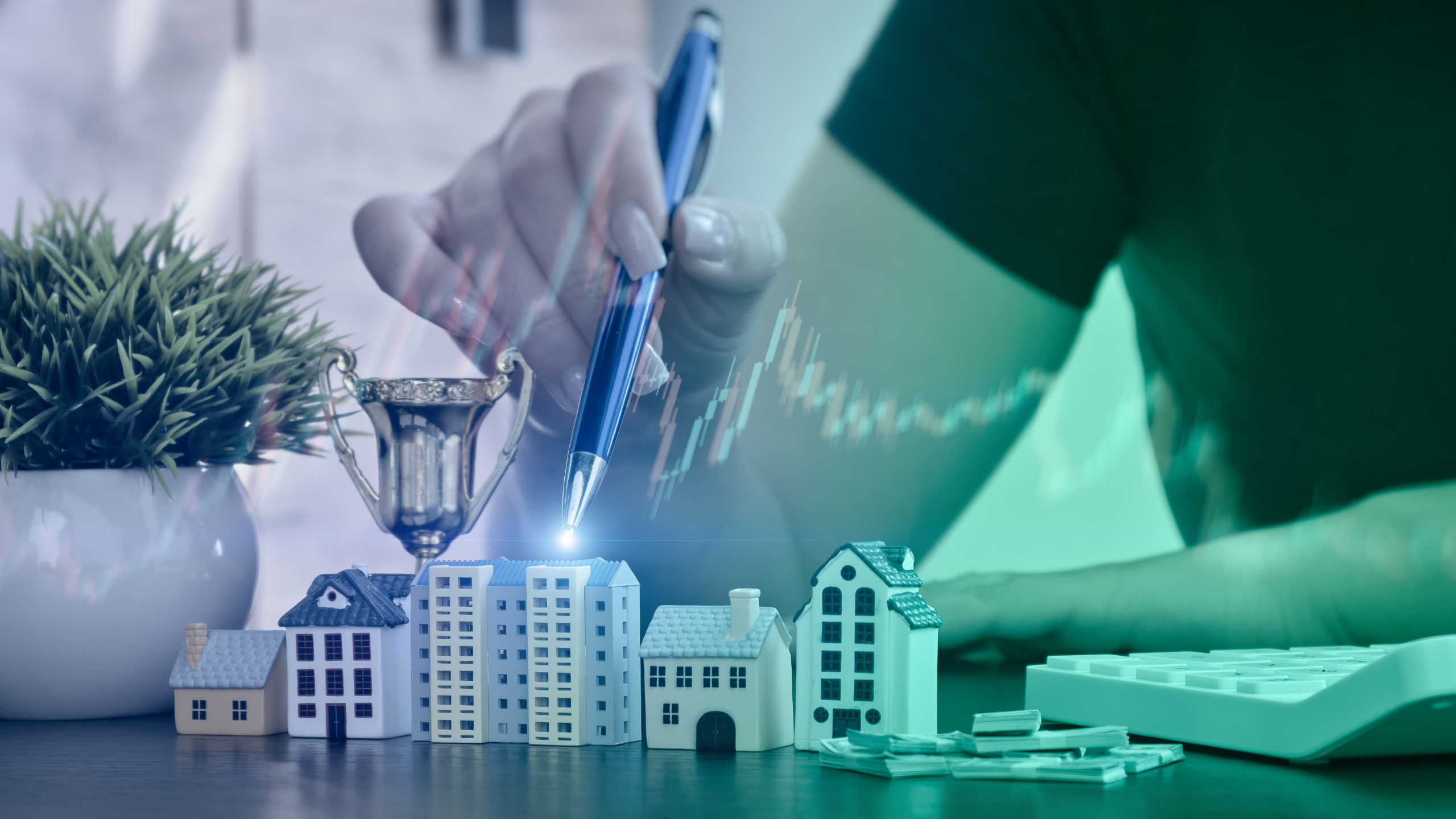 A conceptual image showing a person holding a pen above miniature model houses, a small trophy, and a stack of money, symbolizing success and investment in real estate. A digital financial graph overlay rises across the scene, representing market growth or property value trends.