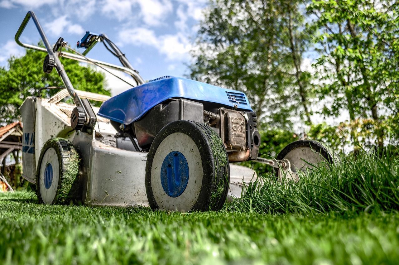 Close-up of a lawnmower cutting grass in a garden, used by a Beckenham estate agent to highlight the importance of kerb appeal and outdoor presentation when selling a home.
