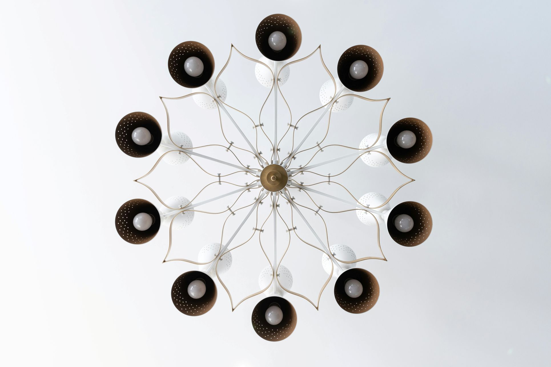 Modern decorative ceiling light fixture with multiple black and white lamps arranged in a circular flower-like design, viewed from directly below. The artistic lighting creates a stylish and contemporary focal point for interior spaces, often featured in modern homes and Orpington properties.