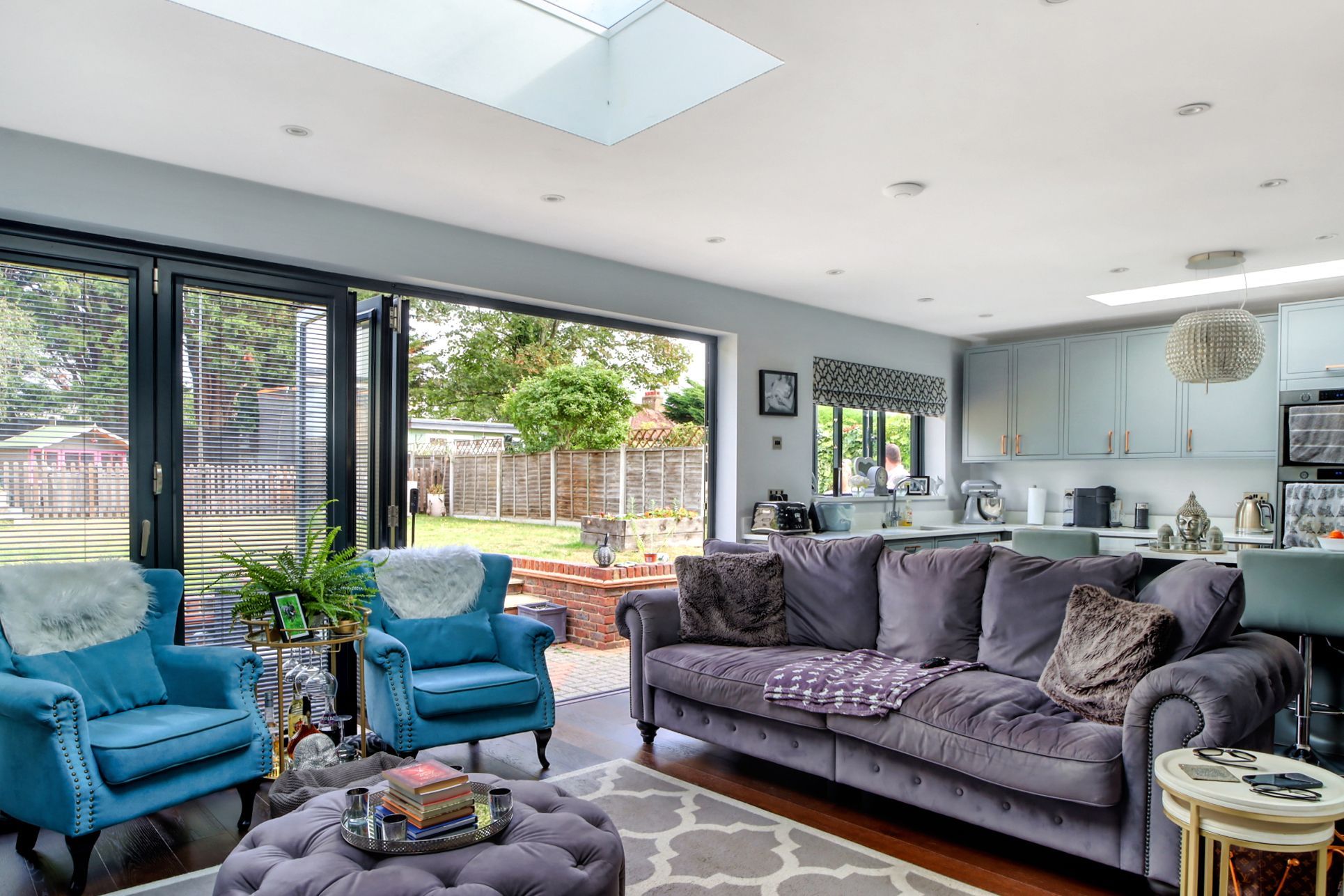 Bright open-plan living room and kitchen with bi-fold doors leading to the garden, styled by a Beckenham estate agent to showcase modern family living.