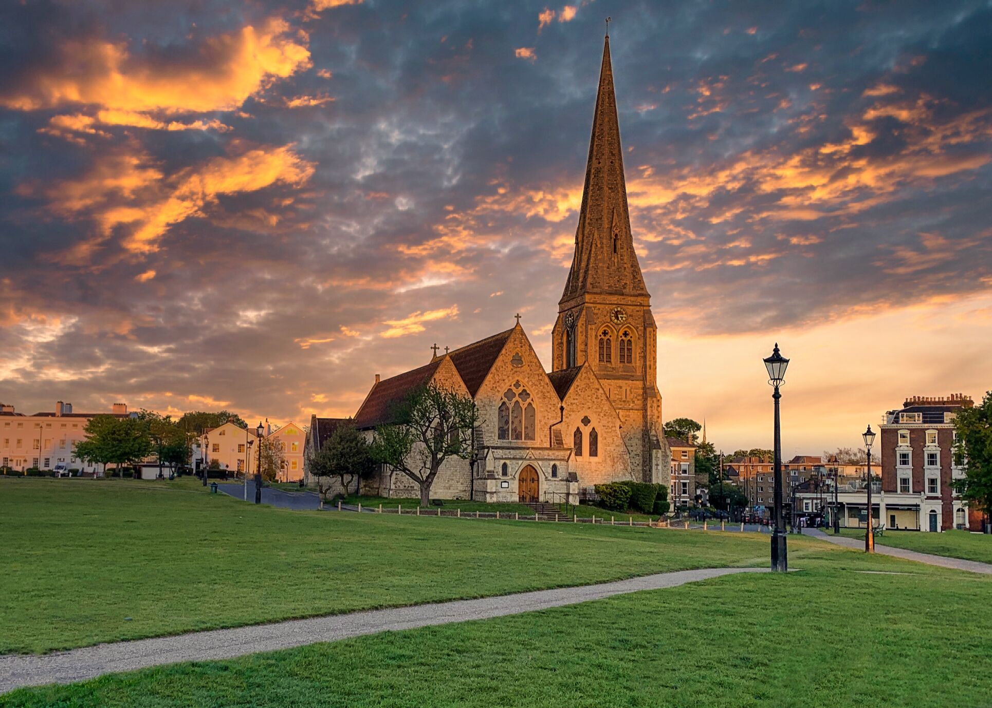 A breathtaking view of a historic church in Blackheath, South East London, captured at sunset with golden skies illuminating its tall spire and Gothic-style stonework. The lush green heath in the foreground contrasts beautifully with the dramatic evening sky, while elegant period homes frame the background. This striking setting highlights why Blackheath remains one of London’s most desirable areas for buyers seeking heritage, charm, and open green spaces. Integra Estates, your trusted Beckenham estate agents, Orpington estate agents, and Penge estate agents, are here to help you buy or sell property in Blackheath and the surrounding areas.