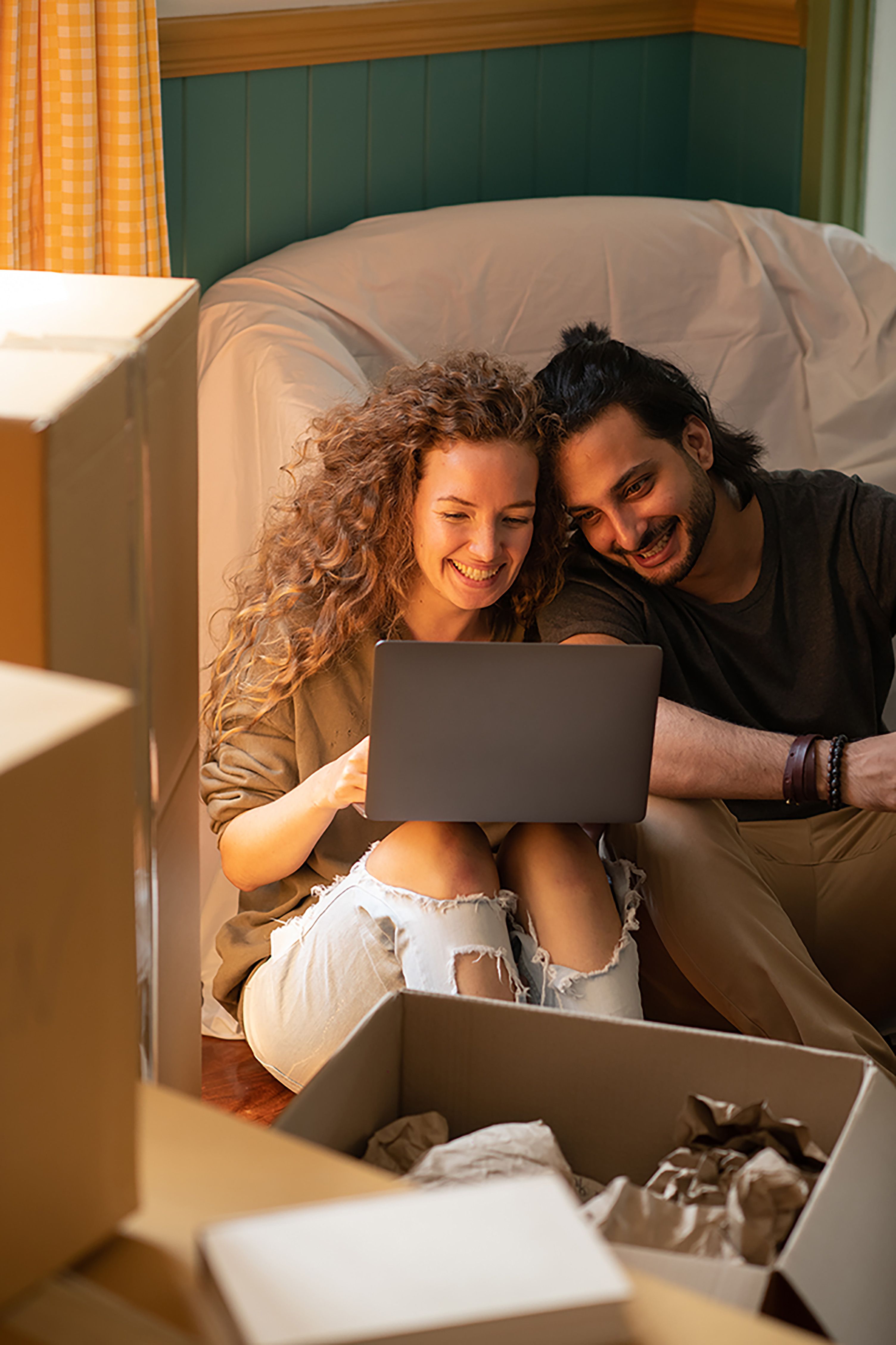 a couple researching on their laptop about their first home